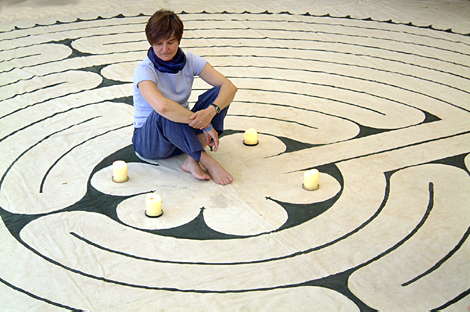 Labyrinth Society founder Helen Curry sits on her awesome canvas Chartres Labyrinth; see cover of Inner Christianity